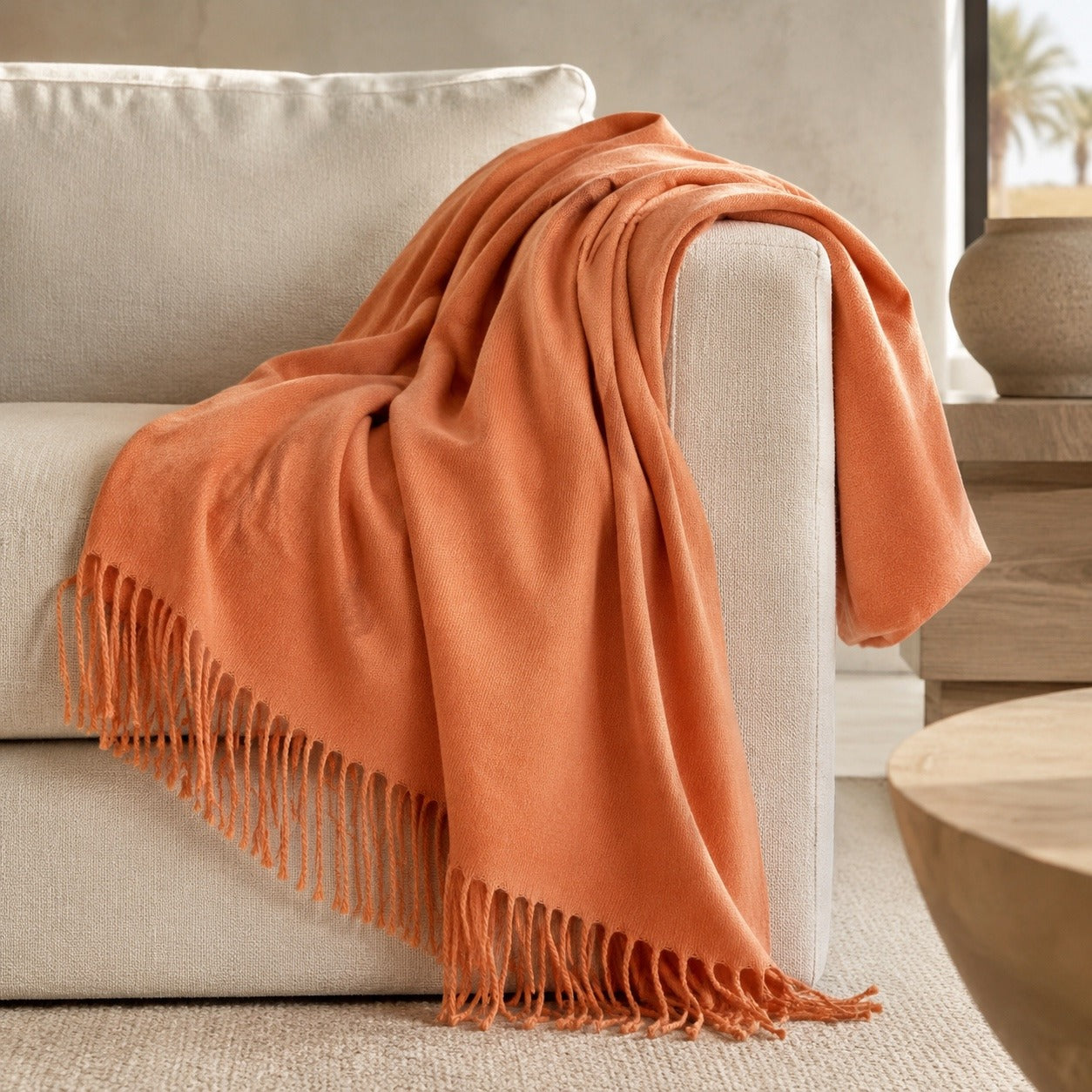 Edinburgh Melon luxury throw styled on a neutral sofa