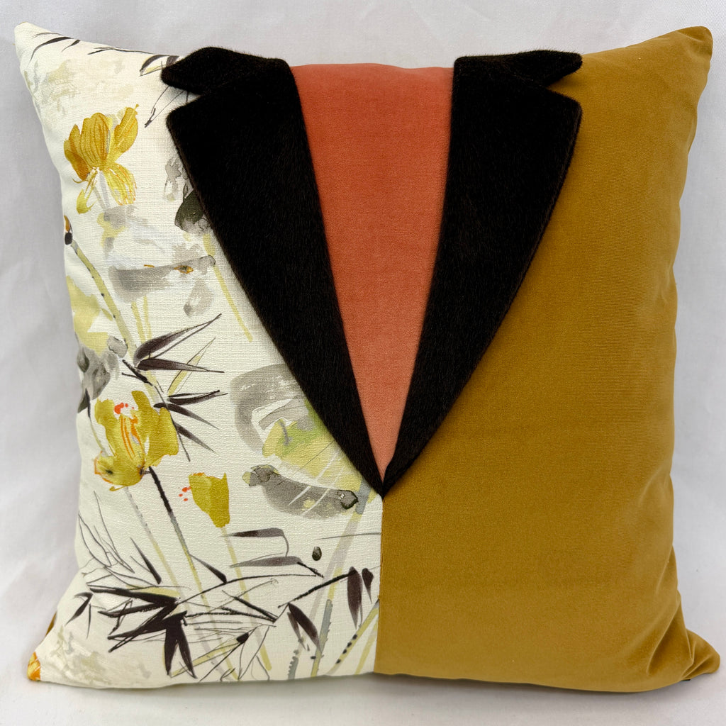A square decorative throw pillow with a creative tuxedo-inspired design. The left half features a cream-colored fabric with a yellow and gray floral print, while the right half is a solid mustard yellow velvet.