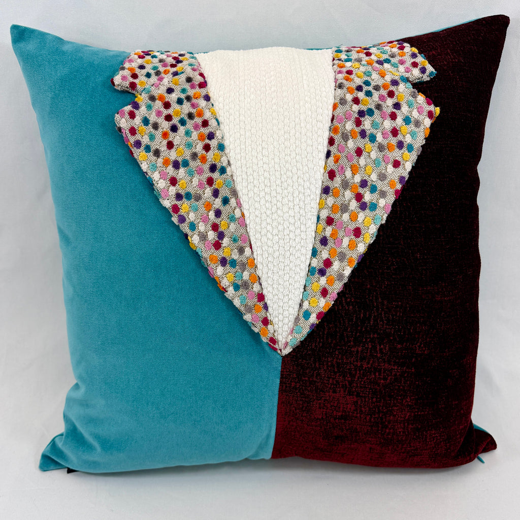 A square decorative throw pillow with a velvet-like split design in teal blue on the left and deep burgundy on the right, featuring a central white textured panel and a colorful embroidered polka-dot border.