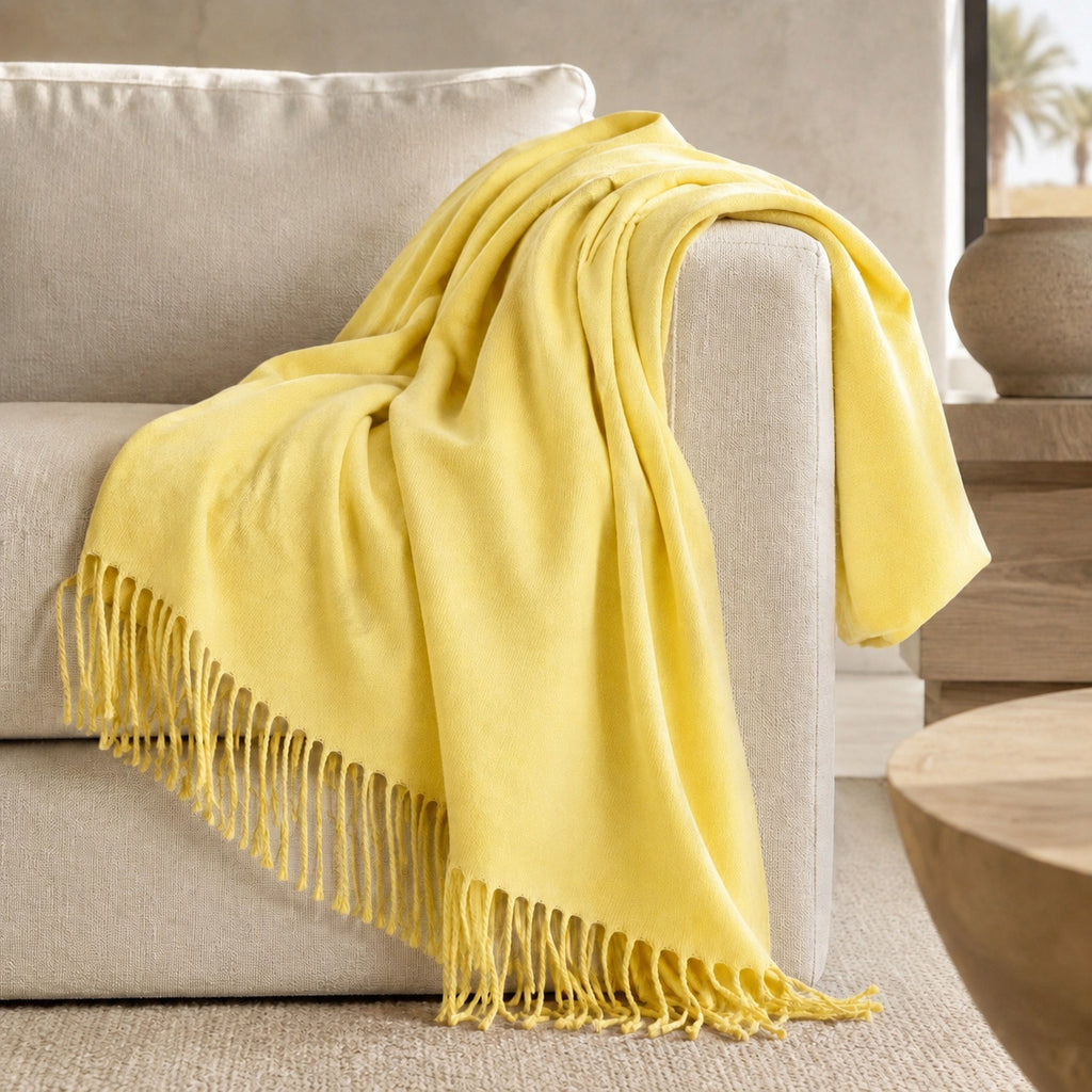 Edinburgh Limoncello luxury throw styled on a neutral sofa