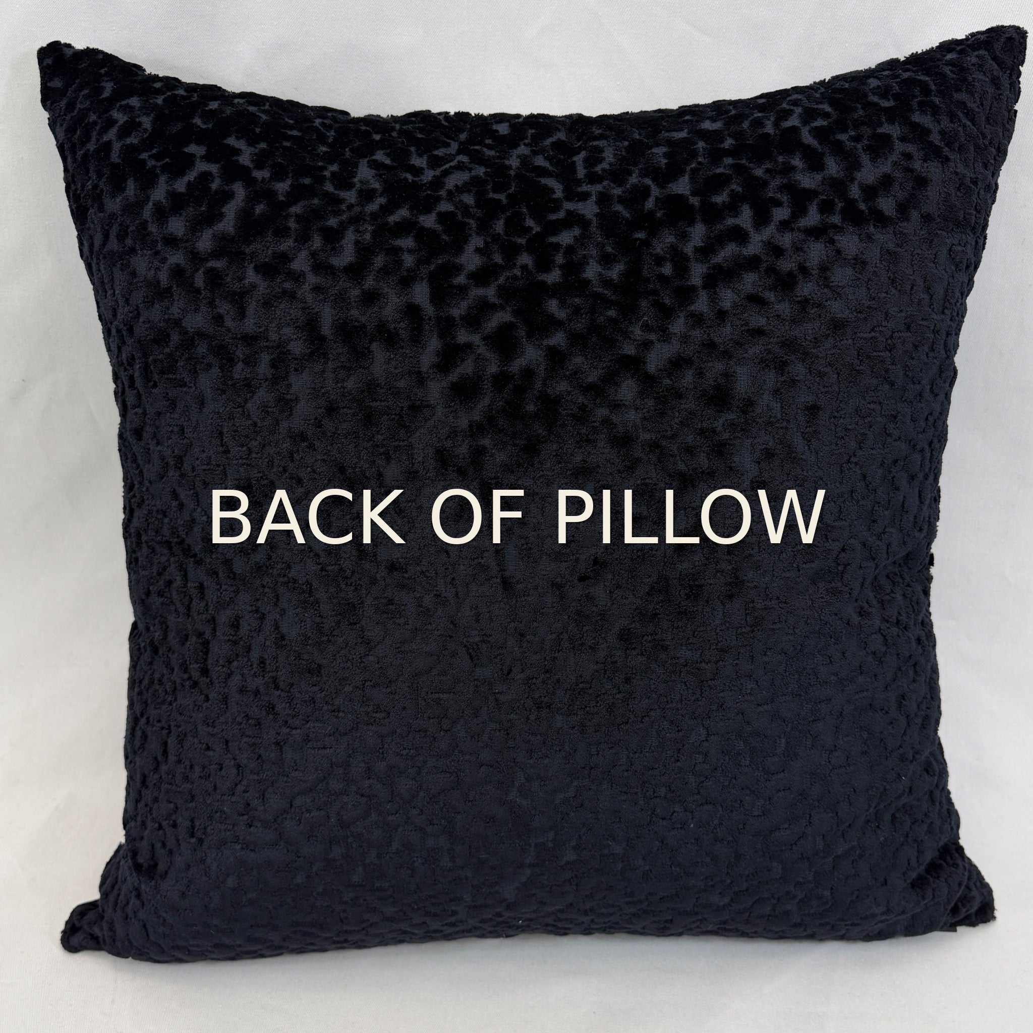 A square throw pillow in a deep navy blue textured fabric, photographed against a neutral light gray background.