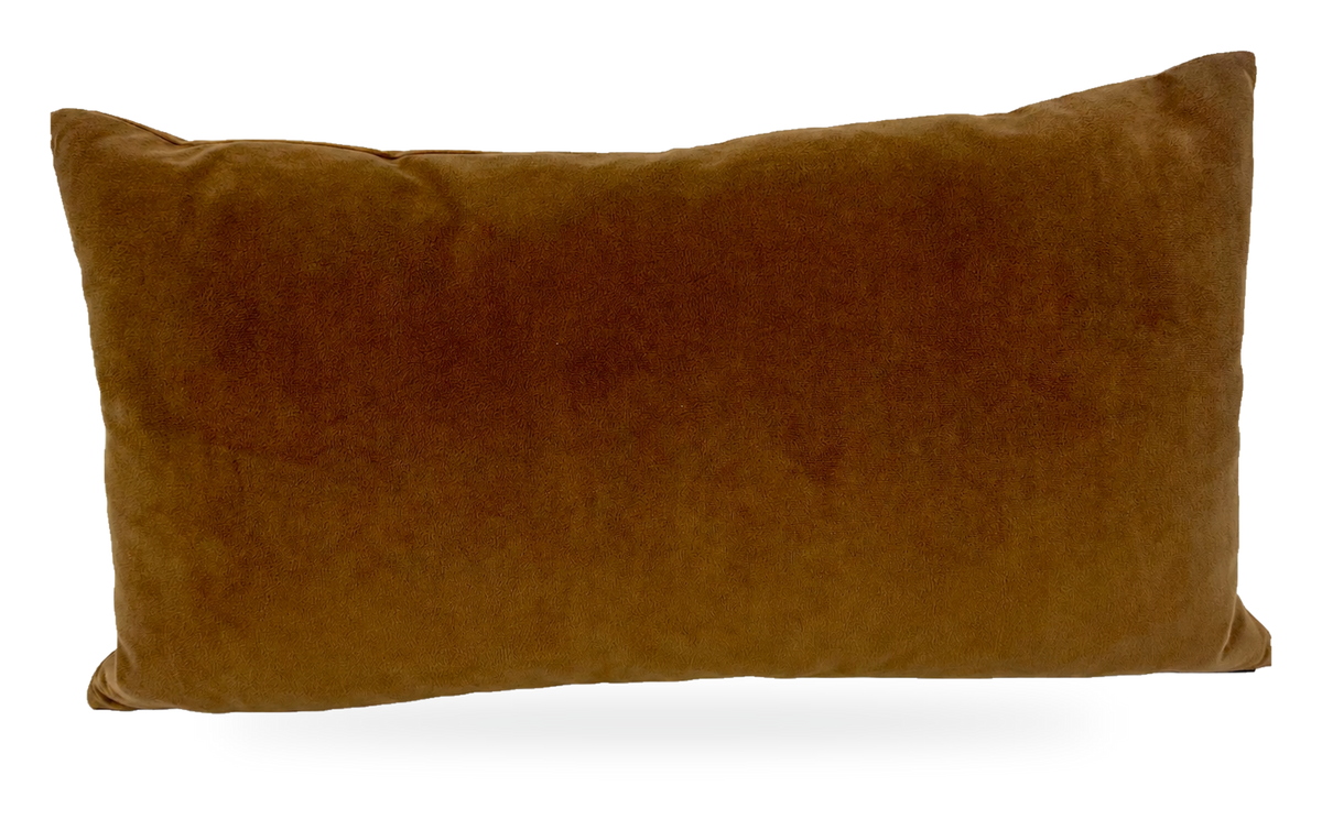 A rectangular lumbar throw pillow in a warm camel brown velvet fabric, photographed against a neutral white fabric backdrop.
