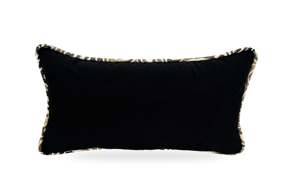 A rectangular black lumbar pillow with a textured leopard-print trim, shown against a plain white background.