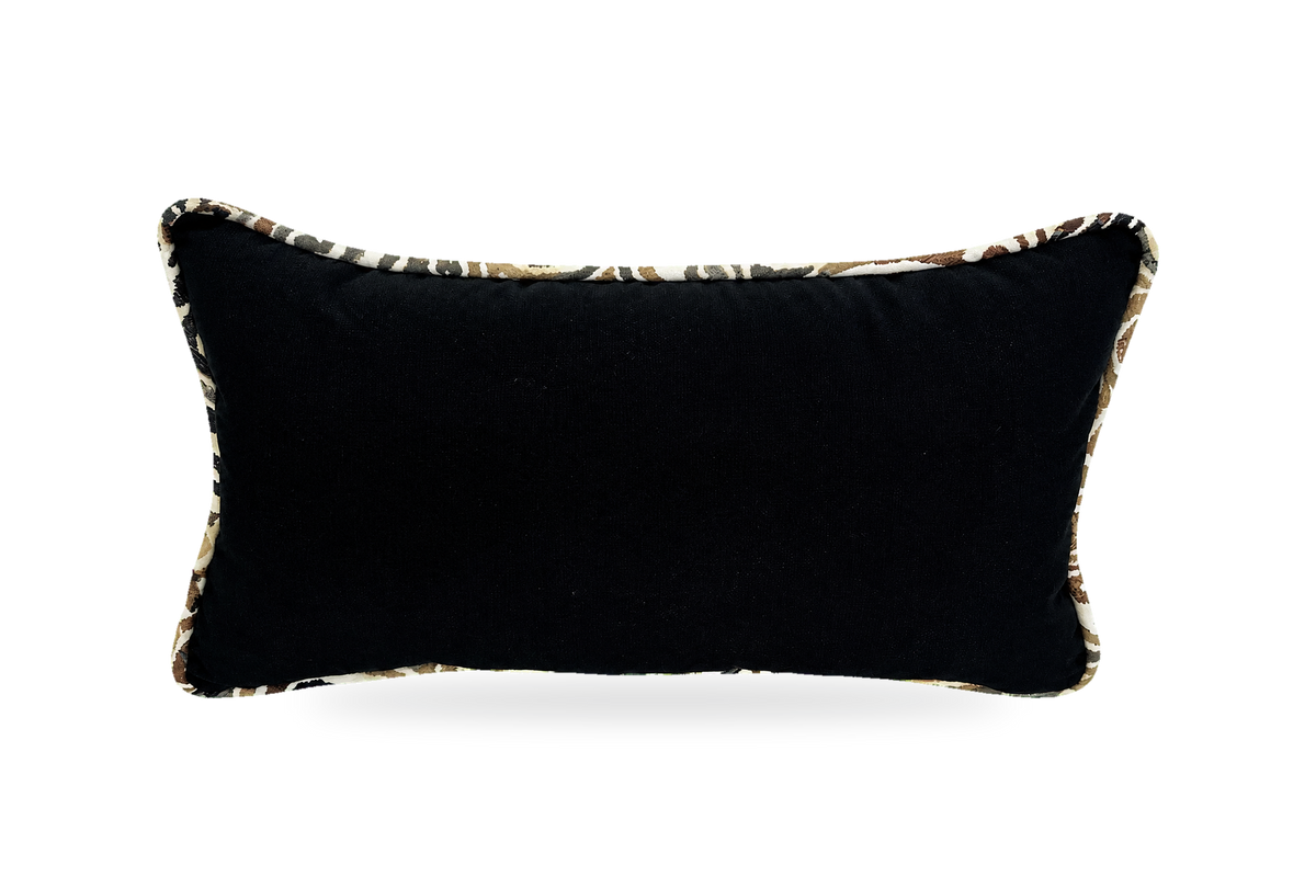 A rectangular black lumbar pillow with a textured leopard-print trim, shown against a plain white background.