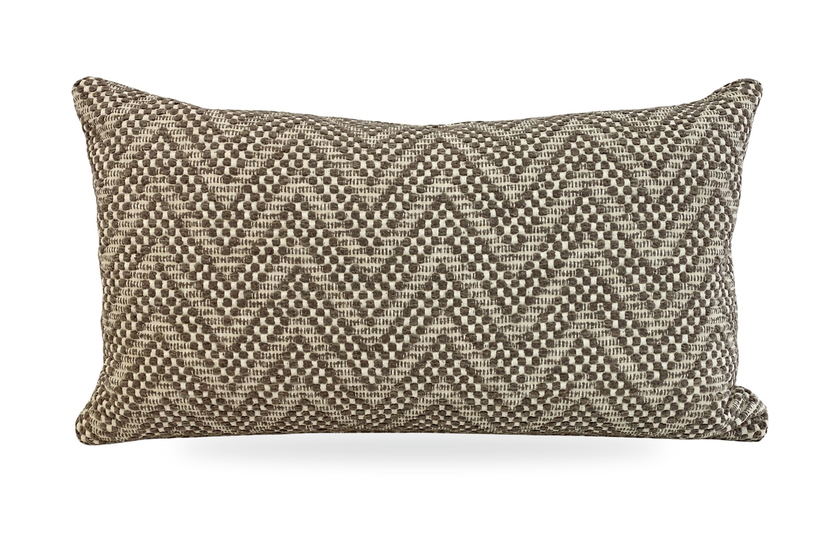 A rectangular lumbar throw pillow featuring a textured chevron pattern woven from beige and brown threads, shown against a plain white background.